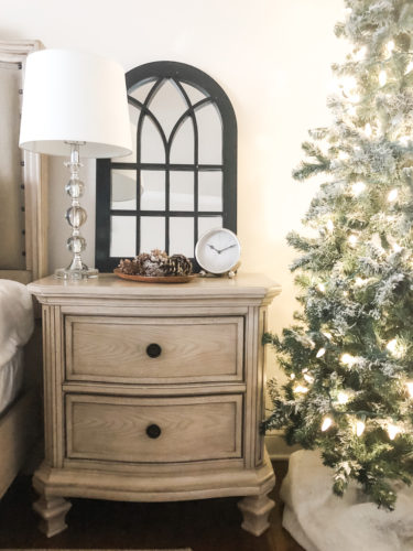 Simple and easy neutral Christmas decor in the bedroom! A Christmas tree, some pinecones and some pine touches complete this space! #christmasbedroom #neutralchristmas