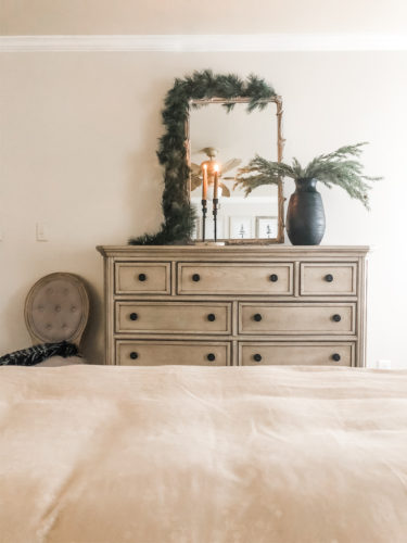 Simple and easy neutral Christmas decor in the bedroom! A Christmas tree, some pinecones and some pine touches complete this space! #christmasbedroom #neutralchristmas