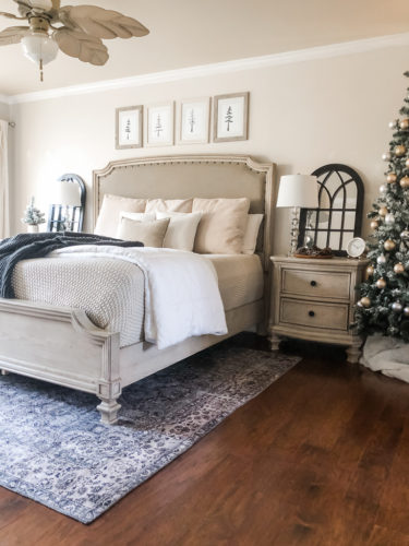 Simple and easy neutral Christmas decor in the bedroom! A Christmas tree, some pinecones and some pine touches complete this space! #christmasbedroom #neutralchristmas