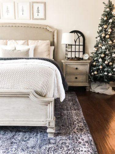 Simple and easy neutral Christmas decor in the bedroom! A Christmas tree, some pinecones and some pine touches complete this space! #christmasbedroom #neutralchristmas