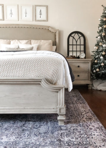 Simple and easy neutral Christmas decor in the bedroom! A Christmas tree, some pinecones and some pine touches complete this space! #christmasbedroom #neutralchristmas