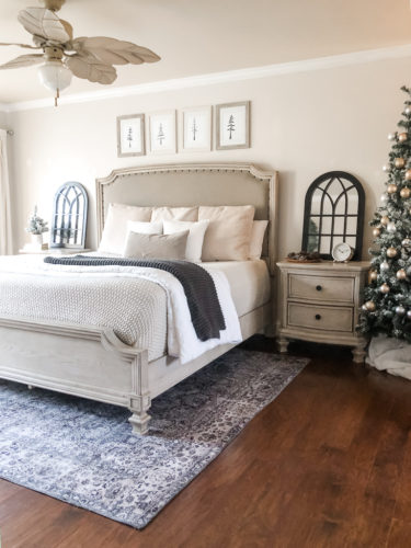 Simple and easy neutral Christmas decor in the bedroom! A Christmas tree, some pinecones and some pine touches complete this space! #christmasbedroom #neutralchristmas