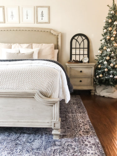 Simple and easy neutral Christmas decor in the bedroom! A Christmas tree, some pinecones and some pine touches complete this space! #christmasbedroom #neutralchristmas