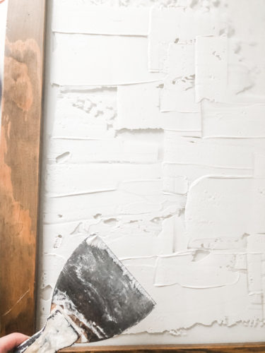 Learn how to make your own expensive-looking textured, abstract wall art. Convert old art paintings into new, modern artwork for your home. This project is super budget-friendly! #DIYWallArt #Abstractarttutorial #texturedwallart #modernart