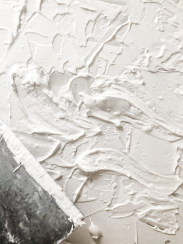 Learn how to make your own expensive-looking textured, abstract wall art. Convert old art paintings into new, modern artwork for your home. This project is super budget-friendly! #DIYWallArt #Abstractarttutorial #texturedwallart #modernart