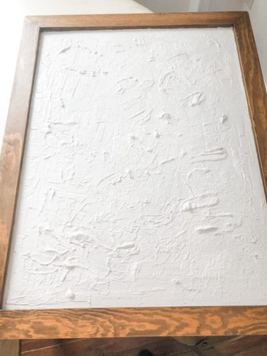 Learn how to make your own expensive-looking textured, abstract wall art. Convert old art paintings into new, modern artwork for your home. This project is super budget-friendly! #DIYWallArt #Abstractarttutorial #texturedwallart #modernart