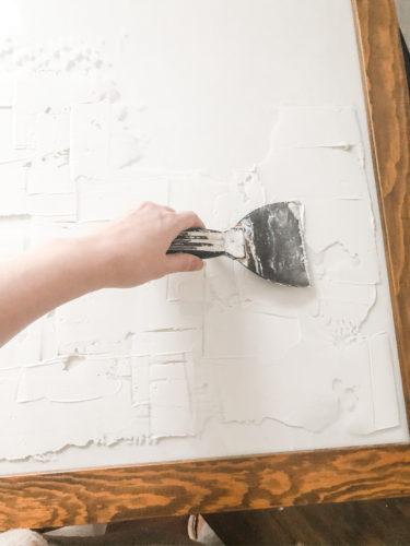 Learn how to make your own expensive-looking textured, abstract wall art. Convert old art paintings into new, modern artwork for your home. This project is super budget-friendly! #DIYWallArt #Abstractarttutorial #texturedwallart #modernart