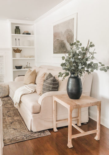 Neutral living room with Studio McGee side table and target finds on the bookcase.