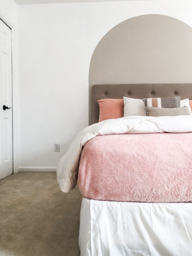 Learn how to paint an arch on a wall in any room for a budget-friendly statement! See how she made a DIY compass to make this large arch look symmetrical. #archonawall