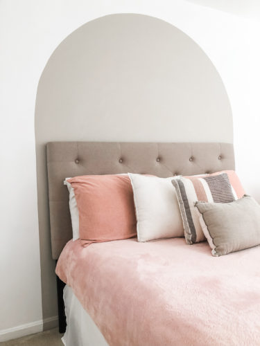 Learn how to paint an arch on a wall in any room for a budget-friendly statement! See how she made a DIY compass to make this large arch look symmetrical. #archonawall