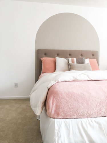 Learn how to paint an arch on a wall in any room for a budget-friendly statement! See how she made a DIY compass to make this large arch look symmetrical. #archonawall