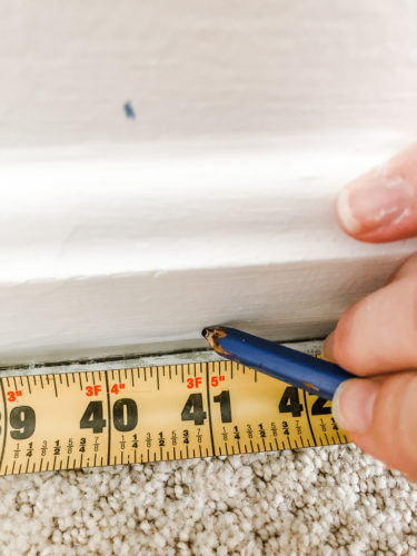 Learn how to paint an arch on a wall in any room for a budget-friendly statement! See how she made a DIY compass to make this large arch look symmetrical. #archonawall