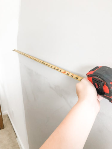 Learn how to paint an arch on a wall in any room for a budget-friendly statement! See how she made a DIY compass to make this large arch look symmetrical. #archonawall