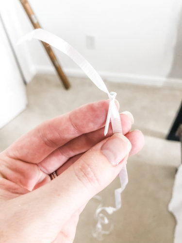 Learn how to paint an arch on a wall in any room for a budget-friendly statement! See how she made a DIY compass to make this large arch look symmetrical. #archonawall