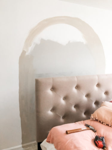 Learn how to paint an arch on a wall in any room for a budget-friendly statement! See how she made a DIY compass to make this large arch look symmetrical. #archonawall
