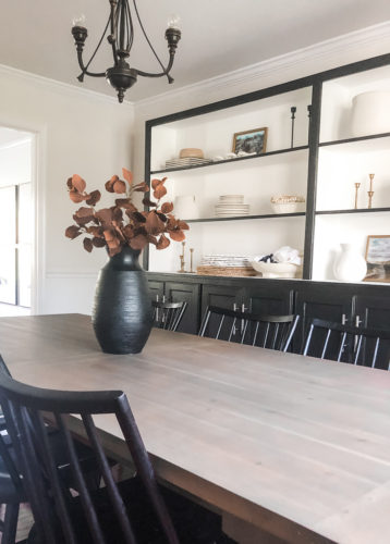 Tips for simple and modern bookcase styling using black, white and cream tones. #modernbookcasestyling #bookcasestyling
