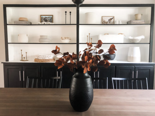 Tips for simple and modern bookcase styling using black, white and cream tones. #modernbookcasestyling #bookcasestyling