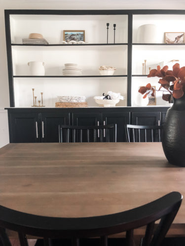 Tips for simple and modern bookcase styling using black, white and cream tones. #modernbookcasestyling #bookcasestyling