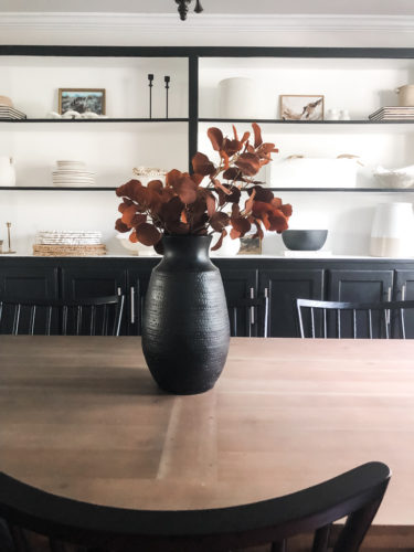 Tips for simple and modern bookcase styling using black, white and cream tones. #modernbookcasestyling #bookcasestyling