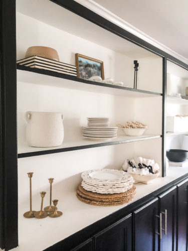 Tips for simple and modern bookcase styling using black, white and cream tones. #modernbookcasestyling #bookcasestyling