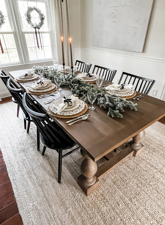 Neutral and rustic Christmas table decor using greenery, antlers and jute chargers #rusticchristmastabledecor #rusticchristmastablescape #rusticchristmasdecor