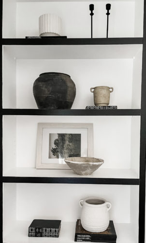 Black and white bookcase with vintage style decor