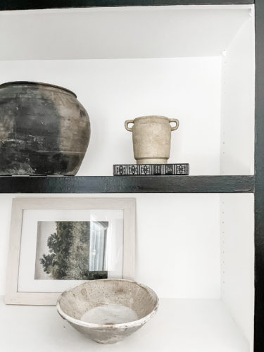 Black and white bookcase with vintage style decor