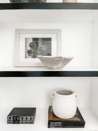 Black and white bookcase with vintage style decor