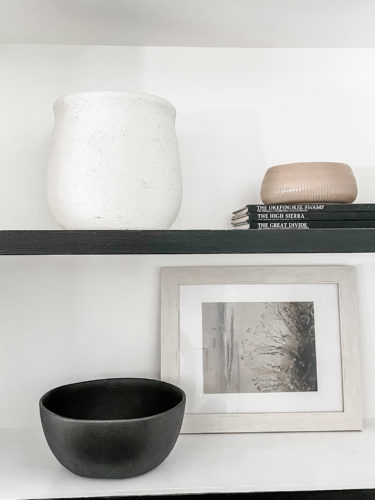 Black and white bookcase with vintage style decor