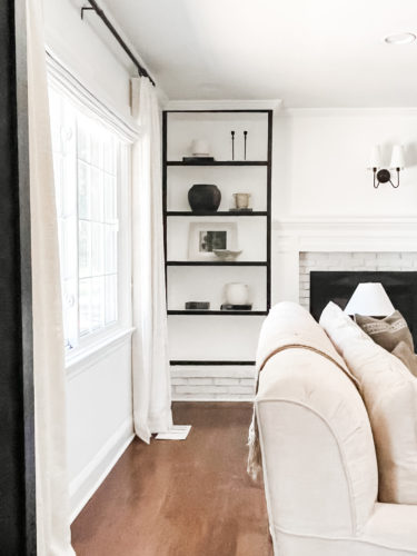 Black and white bookcase with vintage style decor