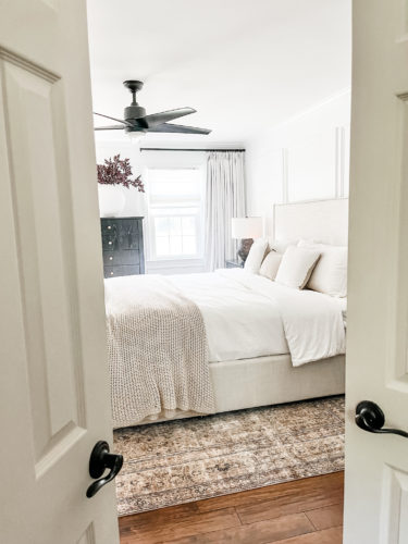 Black and white transitional primary bedroom with picture frame moulding #primarybedroom #transitionalbedroom #blackandwhitebedroom #modernbedroom