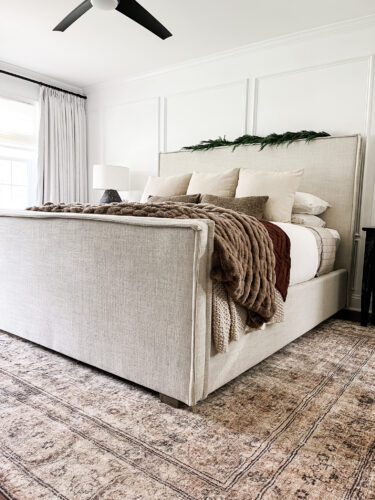 Moody and traditional Christmas bedroom using brown, red and green. Cozy Christmas bedroom decor #christmasbedroom #cozychristmasbedroomdecor