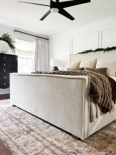Moody and traditional Christmas bedroom using brown, red and green. Cozy Christmas bedroom decor #christmasbedroom #cozychristmasbedroomdecor