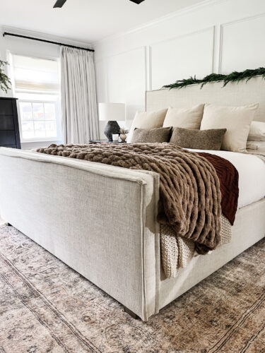 Moody and traditional Christmas bedroom using brown, red and green. Cozy Christmas bedroom decor #christmasbedroom #cozychristmasbedroomdecor