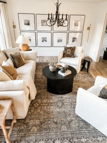 How to layout a living room with a round coffee table, black round coffee table, elegant living room #roundcoffeetable