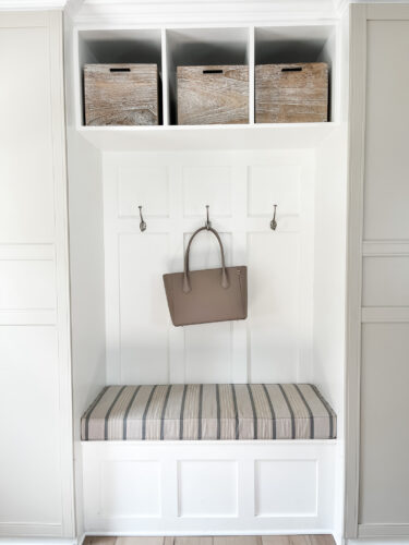 Functional mudroom ideas + picture frame moulding addition in our mudroom entryway.